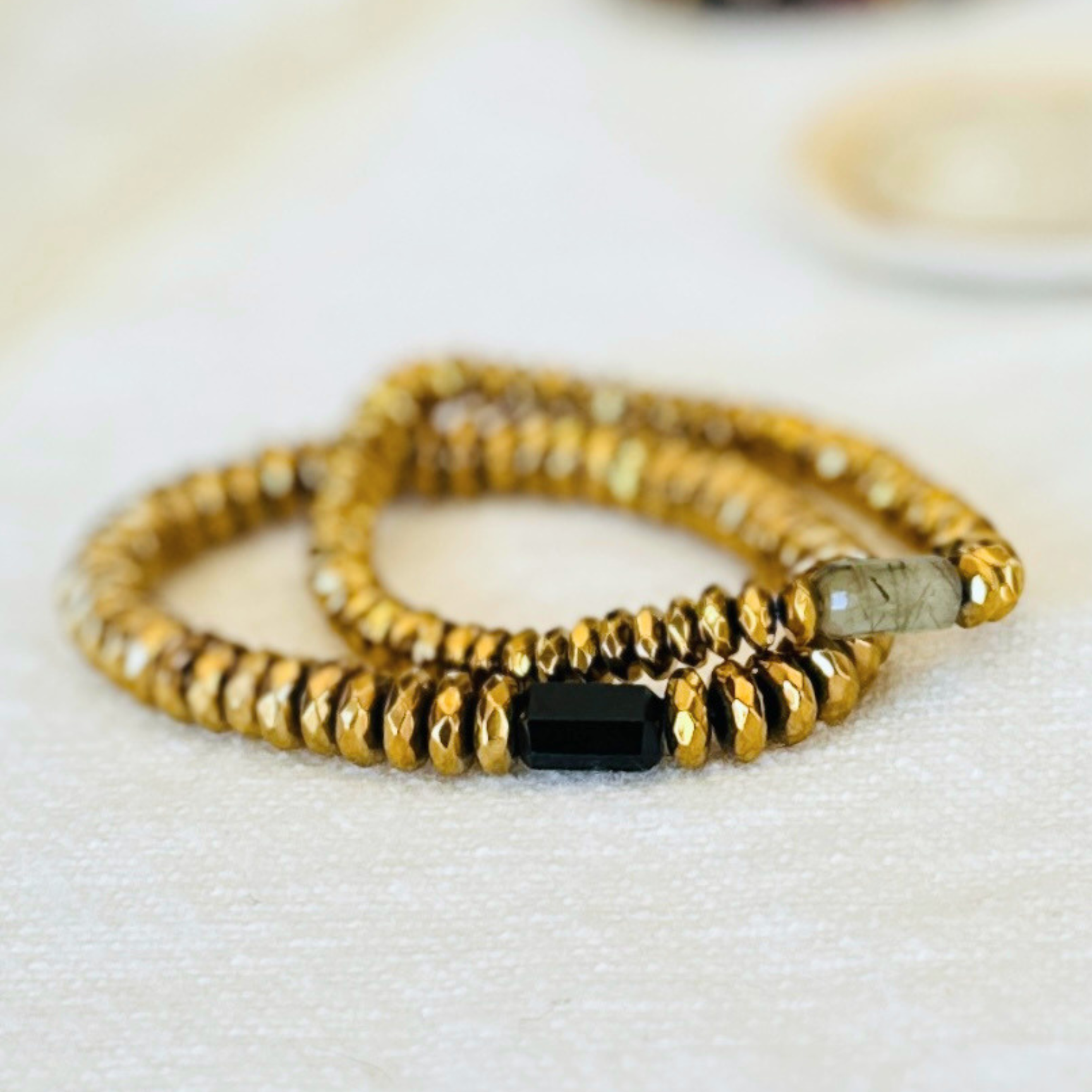 The Afterlight Stack, Wild Elegance and Gilded Anchor bracelets in gold-dipped Hematite