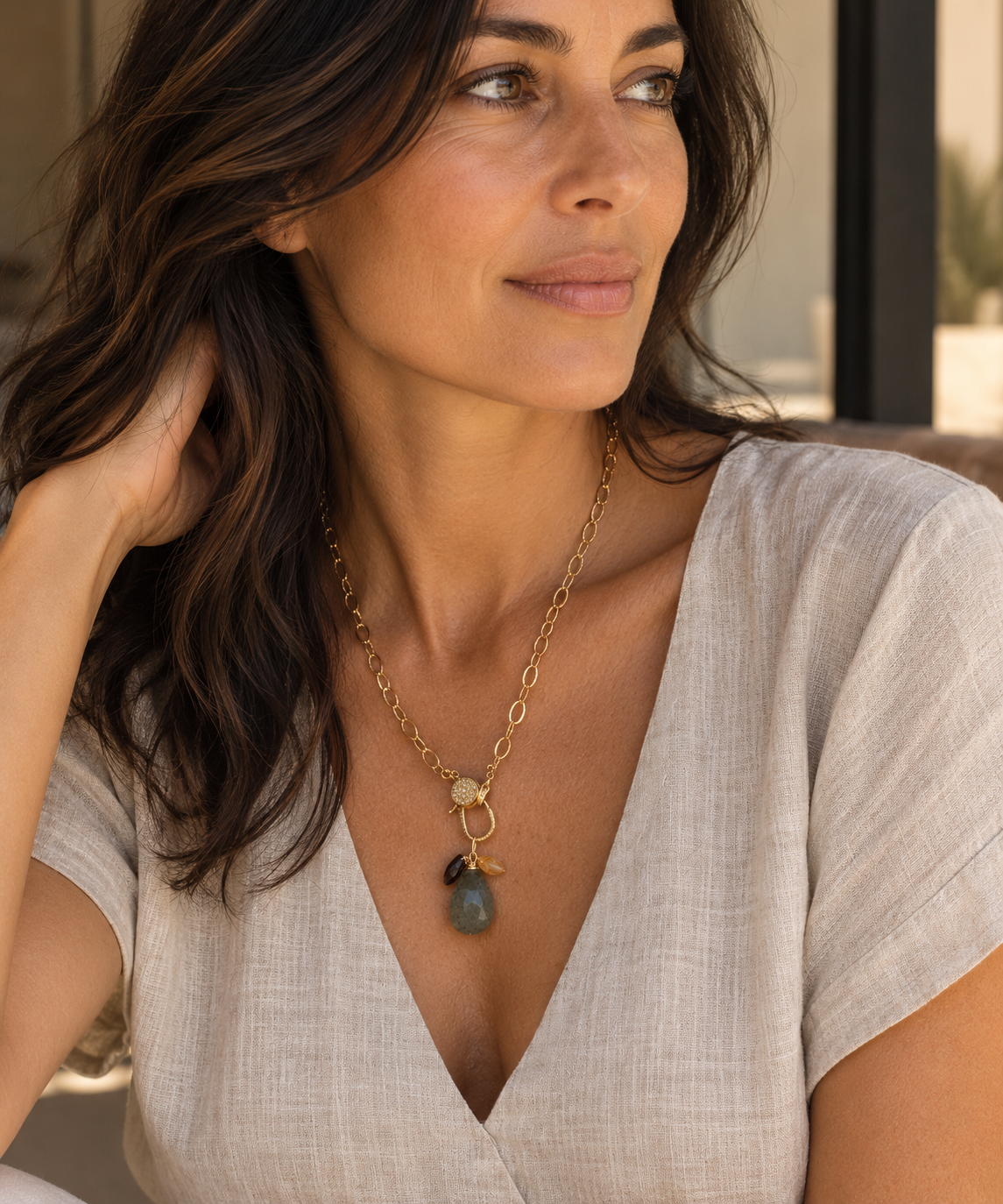 Coastal Cluster Talisman worn on a gold link chain with a linen top