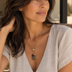 Coastal Cluster Talisman worn on a gold link chain with a linen top